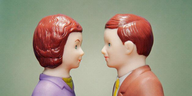 Husband and wife figurines facing each other