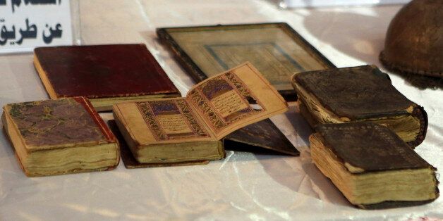 Recovered antique copies of the Quran, Islam's holy book, are displayed at the Iraqi National Museum in Baghdad, Iraq, Wednesday, July 29, 2015. Nearly 400 artifacts looted from Iraq amid the chaos of the 2003 U.S.-led invasion that toppled former Iraqi President Saddam Hussein were recovered by the Iraqi authorities recently from several sources. (AP Photo/Khalid Mohammed)