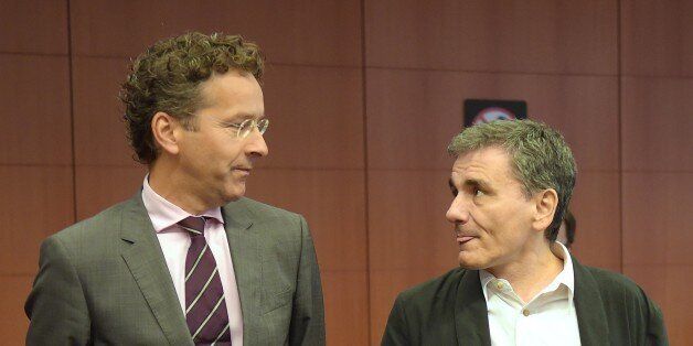 Greece's Finance Minister Euclid Tsakalotos (R) and Eurogroup President and Dutch Finance Minister Jeroen Dijsselbloem talk during an Eurogroup meeting at the EU headquarters in Brussels, on August 14, 2015. Greece's huge debt mountain remains a 'major point of concern' as eurozone finance ministers discuss whether to endorse a third bailout-for-reform deal, Eurogroup head Jeroen Dijsselbloem said. AFP PHOTO / EMMANUEL DUNAND (Photo credit should read EMMANUEL DUNAND/AFP/Getty Images)