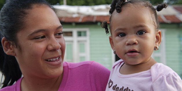 Very cute baby girl and her mother, in the town of Barahona, Dominican