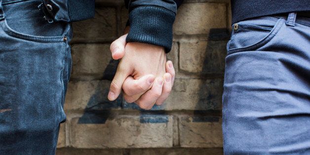 China, Hong Kong, close-up of gay couple holding hands