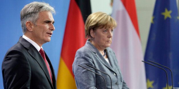German Chancellor Angela Merkel, right, and Austrian Chancellor Werner Faymann, left, address the media during a joint press conference after a meeting at the chancellery in Berlin, Germany, Tuesday, Sept. 15, 2015. Merkel said her country and Austria are calling for a special European Union summit next week to discuss the continentâs migration crisis. (AP Photo/Michael Sohn)