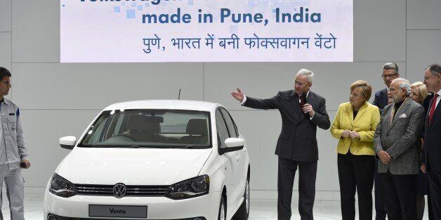 German Chancellor Angela Merkel (5th R) and Indian Prime Minister Narendra Modi (3rd R) listen to Martin Winterkorn (C), CEO of German car maker Volkswagen (VW), presenting a Volkswagen Vento car made in India, at the Hannover Messe industrial trade fair in Hanover, central Germany on April 13, 2015. India is the partner country of this year's trade fair running until April 17, 2015. AFP PHOTO / TOBIAS SCHWARZ (Photo credit should read TOBIAS SCHWARZ/AFP/Getty Images)