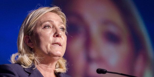 President of France's far right National Front party Marine Le Pen talks during a meeting organised by Flemish far right party Flemish Interest, at the Flemish Parliament in Brussels on Tuesday, Sept. 15, 2015. (AP Photo/Geert Vanden Wijngaert)