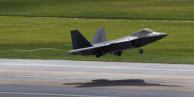 FILE - In this Aug. 14, 2012 file photo, a U.S. Air Force F-22 Raptor stealth fighter takes off from Kadena Air Base on the southern island of Okinawa in Japan. In its first months of combat in the skies above Iraq and Syria in 2015, the F-22 has been more of an escort role, using its high-tech sensors and communications to guide and protect other fighters that are actually dropping the bombs. (AP Photo/Greg Baker, File)