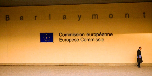 Belgium, Wallonia, Brussels; A beaurocrat passing in front of the European Commision Headquarters in central Brussels