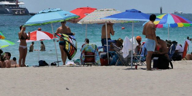 In this, Saturday, Aug. 8, 2015 photo, beach goers enjoy a day on the sand on South Beach, in Miami Beach, Fla. European visitation to Florida was up 6 percent from 2013 to 2014, the most recent totals available. About 4 million Europeans visited the state, according to Visit Florida, the stateâs tourism agency. Florida beach tourism leaders say they are getting a boost in European visitors this summer because of the turmoil in Greece and the Middle East. (AP Photo/Wilfredo Lee)
