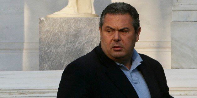 Greek Defense Minister Panos Kammenos, who heads the government's junior coalition member Independent Greeks, leaves Maximos Mansion after after his meeting with the Greek Prime Minister Alexis Tsipras in Athens, Monday, July 13, 2015. After months of acrimony, Greece clinched a preliminary bailout agreement with its European creditors on Monday that will, if implemented, secure the country's place in the euro and help it avoid financial collapse. (AP Photo/Petros Karadjias)