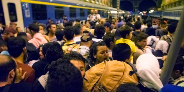 Migrants wait to board a train to Germany at the Keleti Railway Station in Budapest, Hungary, Tuesday, Sept, 1, 2015. (Zoltan Balogh/MTI via AP)