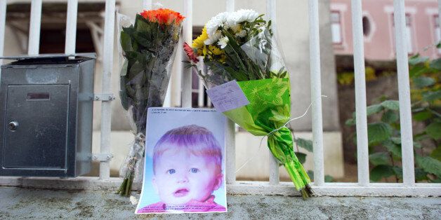 Flowers and a picture of three-year-old child Bastien are seenat the entrance of the child's parents house on November 28, 2011 in Germinuy L Eveque, 40 km east of Paris. Police in France have charged a 33-year-old father with murder after he allegedly killed his three-year-old son by stuffing him into a washing machine and turning it on. The man, identified in reports as Christophe Champenois, was charged with 'murder of a minor' late Sunday in the city of Meaux near Paris, court sources said. AFP PHOTO / MARTIN BUREAU (Photo credit should read MARTIN BUREAU/AFP/Getty Images)