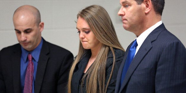 Michelle Carter appears for a hearing in court with her attorneys Cory Madera, left, and Joseph Cataldo, Thursday, April 23, 2015, in New Bedford, Mass. The Bristol district attorney's office says it has no conflict of interest in the case of Carter, a Massachusetts high school student charged with encouraging a friend to kill himself. However, Carter's defense team has requested the case be moved out of Bristol County because the district attorney is the victim's third cousin. (John Wilcox/The Boston Herald via AP, Pool)
