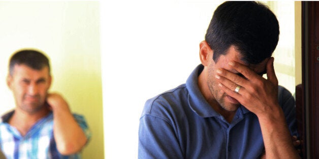 Abdullah Kurdi, 40, father of Syrian boys Aylan, 3, and Galip, 5, who were washed up drowned on a beach near Turkish resort of Bodrum on Wednesday, cries as he waits for the delivery of their bodies outside a morgue in Mugla, Turkey, Thursday, Sept. 3, 2015.(AP Photo/Mehmet Can Meral)