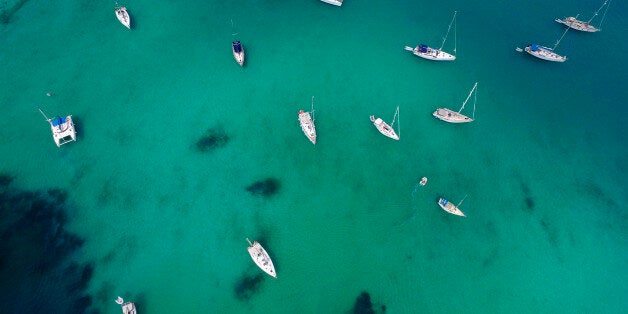 PAXOS, GREECE - AUGUST 08: Aerial view of The Lakka bay on August 08, 2015 in Paxos, Greece.Lakka is a popular tourist destination for yachting, windsurfing, snorkeling and swimming. The two main beaches within the Lakka bay, white pebbled Kanoni and sandy Harami lead to a very clear turquoise sea.(Photo by Athanasios Gioumpasis/Getty Images)