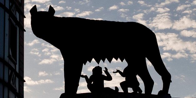 The statue of the she wolf feeding the mythical founders of the city of Rome, the twins Romulus and Remus, a 1906 gift from Rome to the Romanian capital, is silhouetted against the sunset sky downtown Bucharest, Romania, Tuesday, Sept. 16, 2014. Romania's education minister Remus Pricopie grabbed headlines and the latin origin proud country's wide attention after mistakenly stating during a television show that the twins were fed by a fox instead of a she wolf. (AP Photo/Vadim Ghirda)