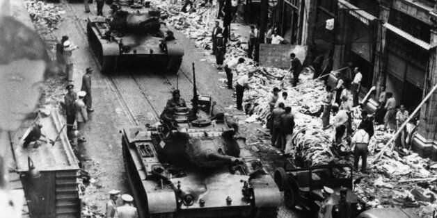 Turkish Army tanks roll through the streets of Istanbul past piles of pillaged goods following the anti-Greek riots, Sept. 8, 1955. The mob disorders touched off by the dynamiting of the Turkish consulate in Salonik, Greece, caused damage estimated at least 35-million dollars and threatened Greek-Turkish military cooperation in the upcoming NATO maneuvers. (AP Photo)