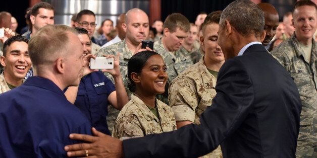From left, Senior Chief Petty Officer Michael Hvozda watches as PFC Melanie Bowroth shakes hands with President Obama after a town hall meeting with service members at Fort Meade in Maryland on Friday, Sept. 11, 2015, the 14th anniversary of the September 11 terrorist attacks. (Kim Hairston/Baltimore Sun/TNS via Getty Images)