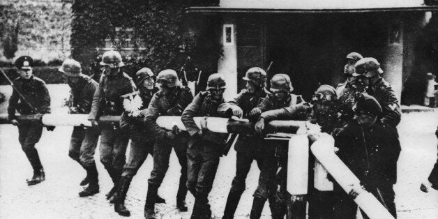 1st September 1939: German troops break down the turnpike at the German-Polish border in Sopot, beginning Germany's invasion of Poland at the start of World War II. This photo was staged a few days after the actual border crossing. (Photo by Keystone/Getty Images)