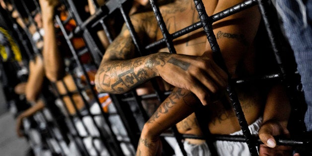 SAN SALVADOR, EL SALVADOR - FEBRUARY 20: Mara Salvatrucha gang members are seen behind the bars of cells at a detention center on February 20, 2013 in San Salvador, El Salvador. Although the murder rate in the country has dropped significantly after a truce between two major street gangs (Mara Salvatrucha and Barrio 18) agreed on 2012, violence and the lack of security are still the main issues in people's daily life. (Photo by Jan Sochor/Latincontent/Getty Images)