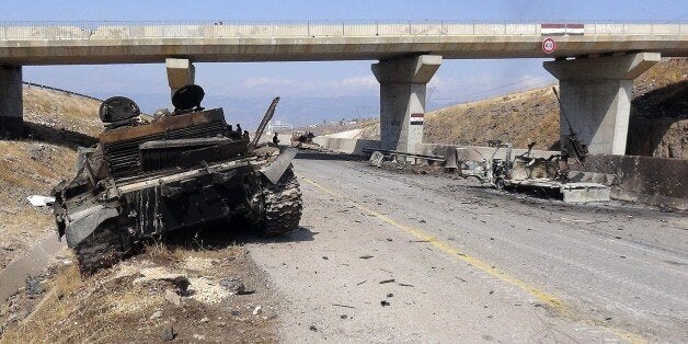 IDLIB, SYRIA - JULY 29: A destroyed tank of Assad forces is seen after Syrian oppositions linked to Fatah forces capture Aleppo, Idlib, Latakia highway, 13 military area and two village, in Idlib, Syria, on July 29, 2015. (Photo by Ibrahim Hatibi/Anadolu Agency/Getty Images)