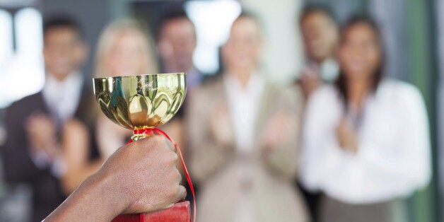 business team winning a trophy