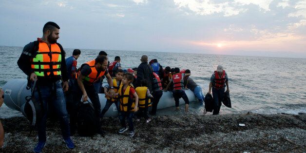 Syrian migrants arrive with an overcrowded dinghy from Turkish coasts at a Mytilene beach, on the northeastern Greek island of Lesvos, early Thursday, June 18, 2015. Around 100,000 migrants have entered Europe so far this year, with some 2,000 dead or missing during their perilous quest to reach the continent. Italy and Greece have borne the brunt of the surge, with many more migrants expected to arrive from June through to September. (AP Photo/Thanassis Stavrakis)