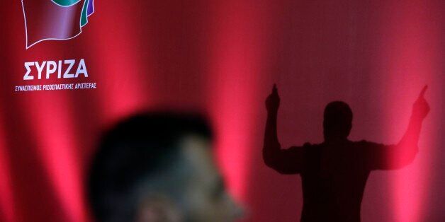 Syriza's leader, former prime minister Alexis Tsipras is silhouetted on a stage (AP Photo/Thanassis Stavrakis)