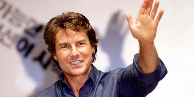 Tom Cruise waves to his fans during the guest visit event for fans to promote his latest movie