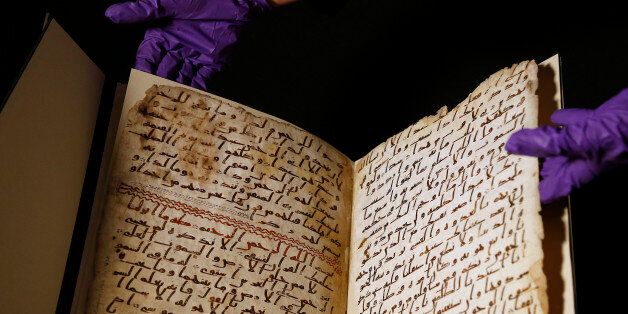 A university assistant shows fragments of an old Quran at the University in Birmingham, in Birmingham central England Wednesday, July 22, 2015. The University of Birmingham said Wednesday that scientific tests prove a Quran manuscript in its collection is one of the oldest known and may have been written close to the time of the Prophet Muhammad. Radiocarbon testing at Oxford University dated the parchment to the time of the prophet, who is generally believed to have lived between 570 and 632.(AP Photo/Frank Augstein)