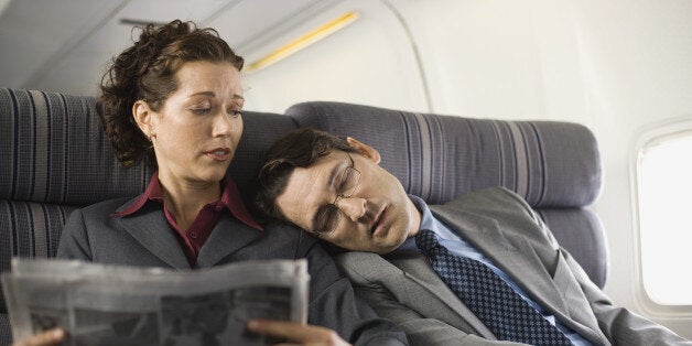 Passengers sleeping and reading on airplane