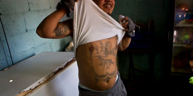 A member of the gang Mara Salvatrucha, MS, shows his tattoo inside the San Pedro Sula prison in Honduras, Tuesday, May 28, 2013. Honduras' largest and most dangerous street gangs have declared a truce, offering the government peace in exchange for rehabilitation and jobs. A Mara Salvatrucha gang spokesman says the gang and its rival, 18th Street, will commit to zero violence and zero crime in the streets as first step show of good faith. (AP Photo/Esteban Felix)