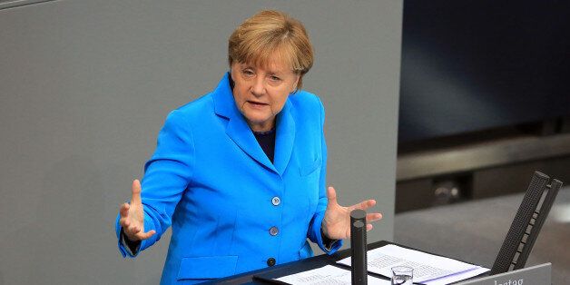 Angela Merkel, Germany's chancellor, gestures as she addresses the lower-house of the Bundestag in Berlin, Germany, on Wednesday, Sept. 9, 2015. The Chancellor said her government's fiscal security will allow it to react to 'newly emerging risks' as faltering markets abroad cause instability in the global economy. Photographer: Krisztian Bocsi/Bloomberg via Getty Images
