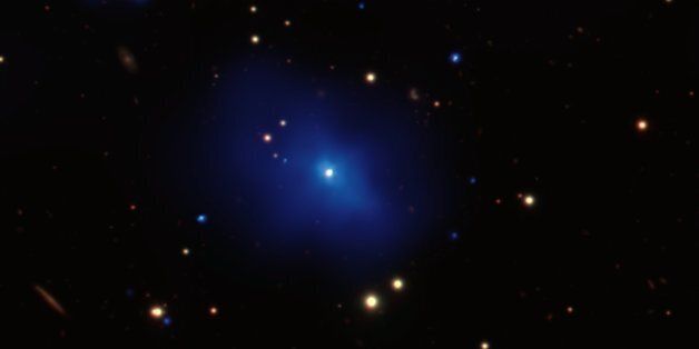 NASA's Chandra X-ray Observatory has observed an unusual galaxy cluster that contains a bright core of relatively cool gas surrounding a quasar called 3C 186. This is the most distant such object yet observed, and could provide insight into the triggering of quasars and the growth of galaxy clusters. This composite image of the cluster surrounding 3C 186 includes a new, deep image from Chandra (blue) showing emission from gas surrounding the point-like quasar near the center of the cluster. Chan