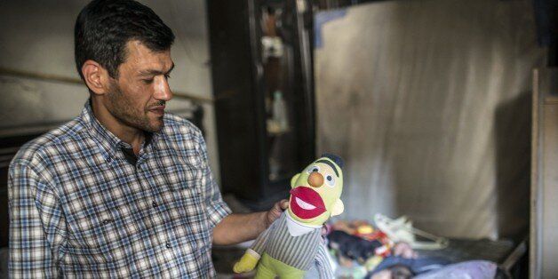 Abdullah Kurdi, father of three-year-old Aylan Kurdi (also know as Aylan Shenu) who drowned off Turkey, Abdullah Kurdi stands in Aylan's room on September 6, 2015 in Kobane. Aylan Kurdi was buried with his four-year-old brother and mother on September 4 in Kobane. They had been living in Damascus but were forced to flee the war's instability which has left more than 240,000 people dead, more than four million have sought refuge in nearby countries, and millions more have been internally displace