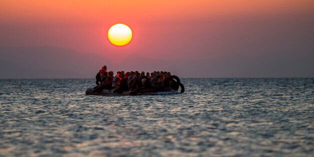 Migrants on a dinghy arrives at the southeastern island of Kos, Greece, after crossing from Turkey, Thursday, Aug. 13, 2015. Greece has become the main gateway to Europe for tens of thousands of refugees and economic migrants, mainly Syrians fleeing war, as fighting in Libya has made the alternative route from north Africa to Italy increasingly dangerous. (AP Photo/Alexander Zemlianichenko)