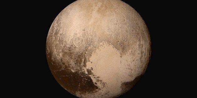 This image made available by NASA on Friday, July 24, 2015 shows Pluto made by combining several images from two cameras on the New Horizons spacecraft. The images were taken when the spacecraft was 280,000 miles (450,000 kilometers) away from Pluto. (NASA/JHUAPL/SwRI via AP)