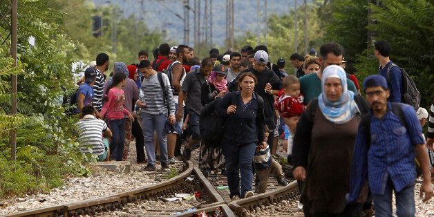 Migrants arrive at the railway station in the southern Macedonia's town of Gevgelija, after breaking through the police blockade on the border with Greece, on Saturday, Aug. 22, 2015. About 39,000 people, mostly Syrian migrants, have been registered as passing through Macedonia in the past month, twice as many as the month before. They previously encountered little resistance at the border, but the recent influx has overwhelmed Macedonian authorities who this week declared a state of emergency and stopped many from crossing. (AP Photo/Boris Grdanoski)