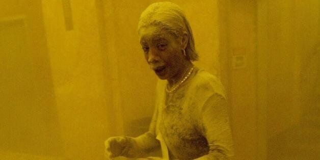 This 11 September 2001 file photo shows Marcy Borders covered in dust as she takes refuge in an office building after one of the World Trade Center towers collapsed in New York. Borders was caught outside on the street as the cloud of smoke and dust enveloped the area. The woman was caught outside on the street as the cloud of smoke and dust enveloped the area. AFP PHOTO/Stan HONDA (Photo credit should read STAN HONDA/AFP/Getty Images)