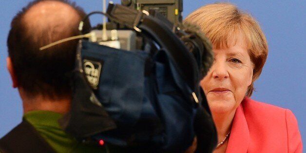 German Chancellor Angela Merkel is filmed as she arrives for a press conference in Berlin on August 31, 2015. AFP PHOTO / JOHN MACDOUGALL (Photo credit should read JOHN MACDOUGALL/AFP/Getty Images)