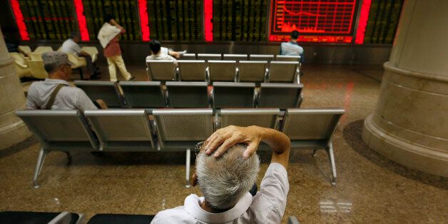 Chinese investors monitor stock prices at a brokerage house in Beijing, Monday, Aug. 24, 2015. Stocks tumbled across Asia on Monday as investors shaken by the sell-off last week on Wall Street unloaded shares in practically every sector. (AP Photo/Mark Schiefelbein)