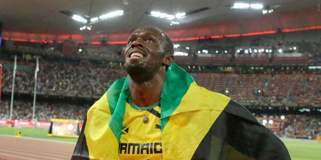 Jamaica's Usain Bolt celebrates after winning the gold medal in the men's 100m ahead of United States' at the World Athletics Championships at the Bird's Nest stadium in Beijing, Sunday, Aug. 23, 2015. (AP Photo/Lee Jin-man)