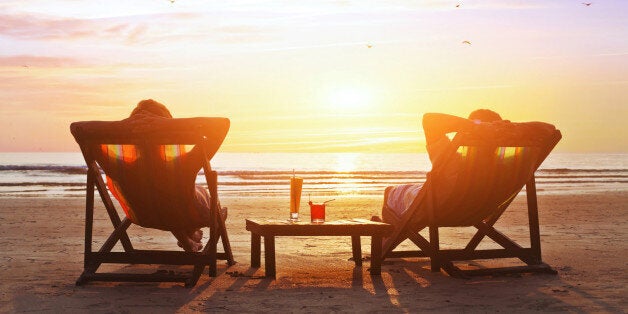 happy couple enjoy luxury sunset on the beach during summer vacations