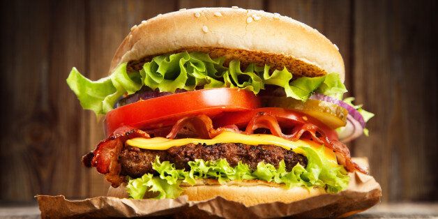 Delicious hamburger on wooden background