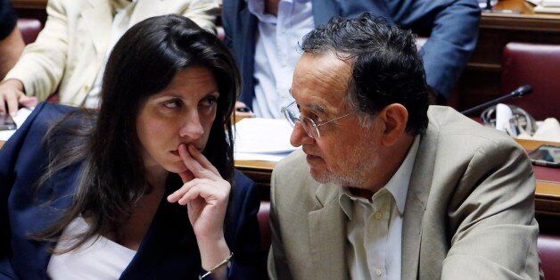 Parliament speaker Zoe Konstantopoulou, left, speaks with Energy Minister Panagiotis Lafazanis during lawmakers meeting of Syriza governing party at the Greek Parliament in Athens, Wednesday, July 15, 2015. Greece's Prime Minister Alexis Tsipras has faced strident dissent even from top ministers, with Lafazanis saying in a post on his ministry's website that the deal the prime minister reached was