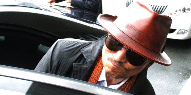 Kenichi Shinoda, the boss of Japan's largest 'yakuza' gang, the Yamaguchi-gumi, gets into a car after arriving at the train station in Kobe, western Japan on April 9, 2011 after he was released from a Tokyo prison after serving time since 2005. AFP PHOTO / JIJI PRESS (Photo credit should read JIJI PRESS/AFP/Getty Images)