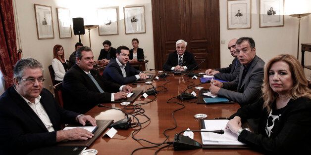 Alexis Tsipras, Greece's prime minister, third left, sits with, from left, Dimitris Koutsoubas, general secretary of the Greek Communist party, Panos Kammenos, leader of the Independent Greeks party, Prokopis Pavlopoulos, Greece's president, Vangelis Meimarakis, president of the New Democracy party, Stavros Theodorakis, president of Potami party, and Fofi Gennimata, president of the PASOK party, ahead of a meeting at the presidential palace in Athens, Greece, on Monday, July 6, 2015. European stocks dropped and the euro weakened as Greek voters' rejection of austerity sent investors to the relative safety of Treasuries, German bunds and the yen. Photographer: Yorgos Karahalis/Bloomberg via Getty Images