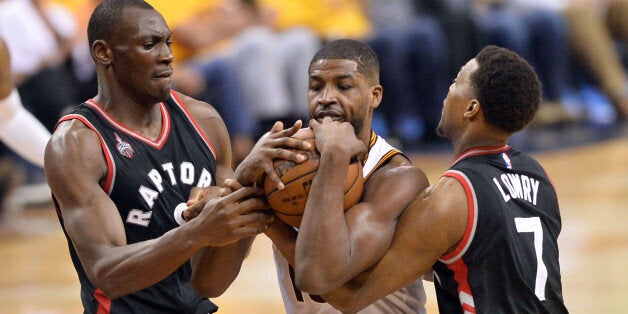 May 25, 2016; Cleveland, OH, USA; Toronto Raptors center Bismack Biyombo (8) and guard Kyle Lowry (7) battle with Cleveland Cavaliers center Tristan Thompson (13) for a loose ball during the second half in game five of the Eastern conference finals of the NBA Playoffs at Quicken Loans Arena. The Cavs won 116-78. Mandatory Credit: Ken Blaze-USA TODAY Sports