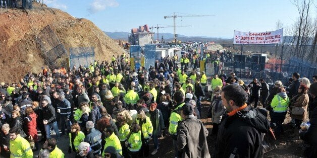 Gold mine workers protest against Greek new leftist government's plan to scrap a gold mine project in the Halkidiki peninsula, northern Greece, outside their mine in Skouries on February 15, 2015. Greece's new leftist government will scrap a controversial gold mine project that has sparked protests in northern Greece, the environment minister said on February 10. Violent resistance has broken out since permission to break ground on the project was granted in 2011 to Hellenic Gold, a Greek subsi