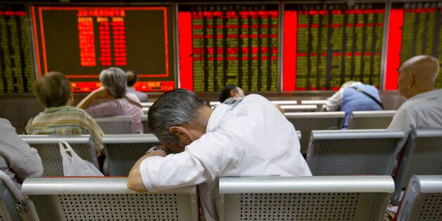 Chinese investors monitor stock prices at a brokerage house in Beijing, Tuesday, Aug. 25, 2015. China's main stock market index has fallen for a fourth day, plunging 7.6 percent to an eight-month low. (AP Photo/Mark Schiefelbein)