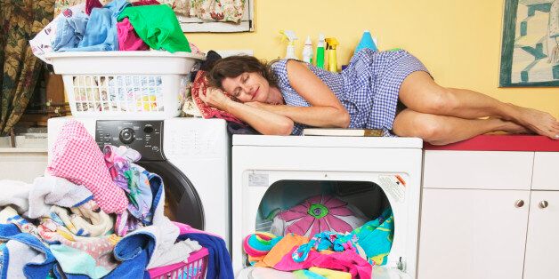 Woman napping while doing laundry