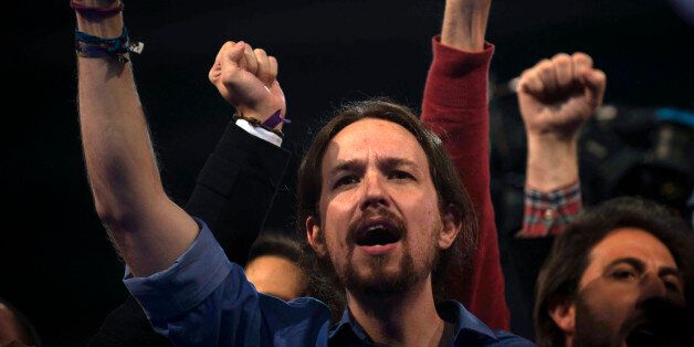 FILE - In this March 20, 2015 file photo, Pablo Iglesias, the leader of Spain's far left 'Podemos' (We Can) party, raises his arm and sings the Andalusian anthem during an electoral campaign rally in Dos Hermanas, Sevilla, Spain. In an announcement Friday July 24, 2015, members of Podemos have made it official: Pony-tailed leader Pablo Iglesias will be the top candidate in general elections expected at the end of this year. Iglesias, a college professor and party co-founder, was picked by 93 per